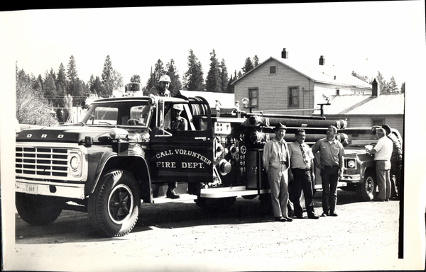 McCall Volunteer Fire Dept., in view there is the fire truck and several men standing with it. Image contains the text: "FORD  McCALL VOLUNTEER FIRE DEPT."