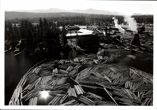 Aerial view of mill and log boom, burner is operating, closer view than 4.41