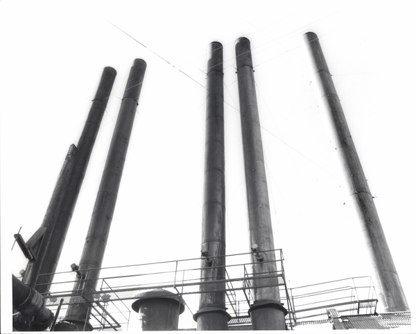 Mill smokestacks used for burning sawdust for steam in the winter