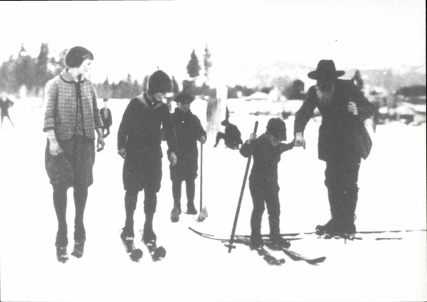 Mixed group of skiers, one skier is a bearded old man