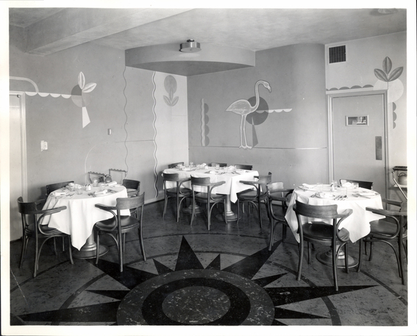 Inside of the Yacht Club in the dinning room section, view of tables and mural