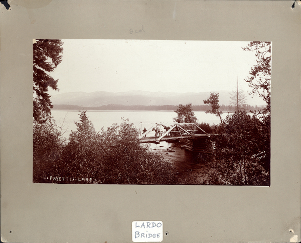 Lardo Bridge, log, with team and wagon loaded with hay bales. Image contains the text: "PAYETTE LAKE  LARDO BRIDGE"