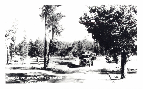 “From your Payette Lakes McCall,Idaho” of an early truck with a log load. Image contains the text: "FROM YOUR PAYETTE LAKES  MCCALL IDAHO"