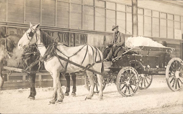 Driver, team, and wagon carrying ice. Image contains the text: "DEPARTMENT STORE THE MO"