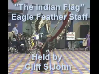 Cliff SiJohn holds "The Indian Flag," the Eagle Feather staff, during the Powwow celebrating the ownership of Lake Coeur d'Alene and the opening of the new tribal Longhouse