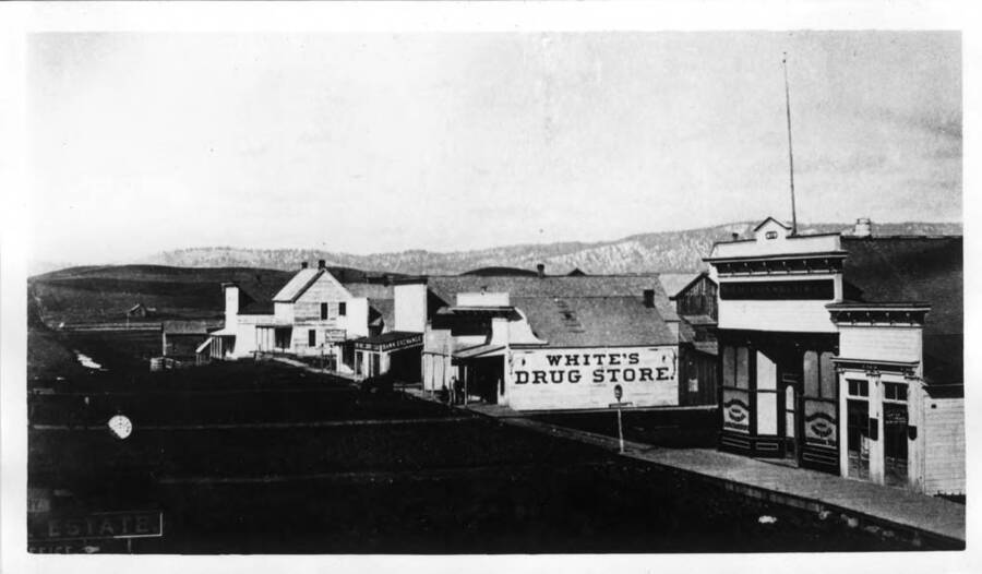 First building on right, Justice of the Peace, next McConnell Store; across First Street, White's Drug Store, Exchange Bank, Commercial Hotel; across A Street, Frie's Brewery with the high front.