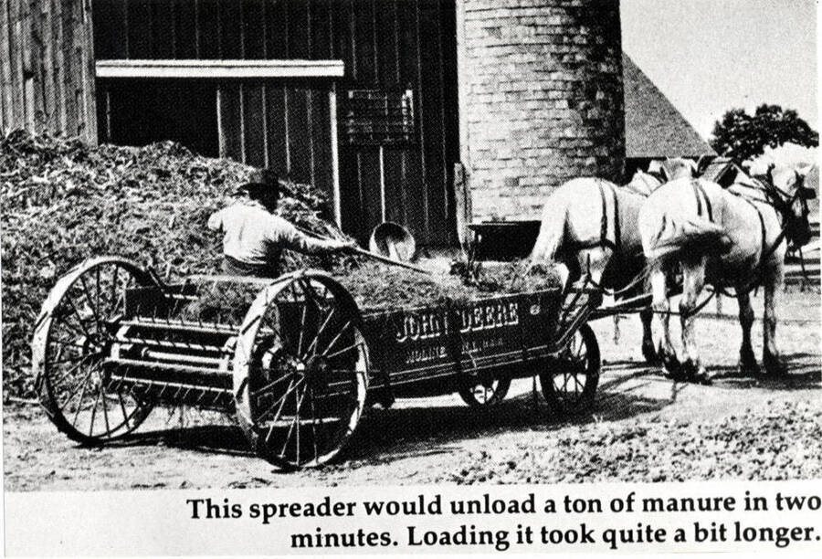 From "The Furrow." November-December 1975 issue. By John Deere Company. Wording on photo: "This spreader would unload a ton of manure in two minutes. Loading it took quite a bit longer."