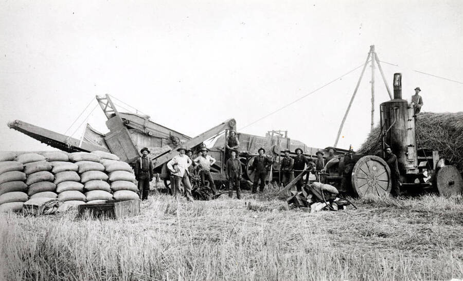 Donkey steam engine powering thresher with a shaft showing from engine to thresher. Near Anatone, Washington. 1906. Courtesy Mr. Welle, Twin Willows Museum, Washington.