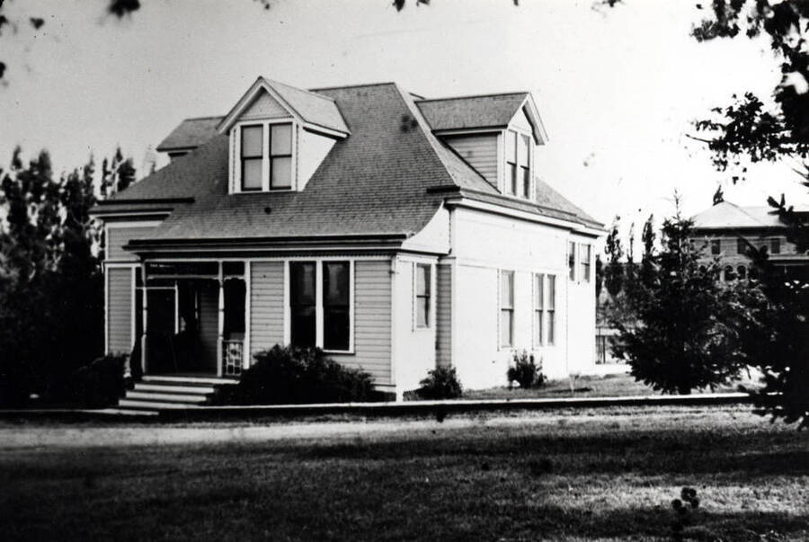 Music Hall, University of Idaho. Located west of Blake Avenue and north of tennis courts. Ridenbaugh Hall at right. Picture taken about 1907 on a glass transparency.