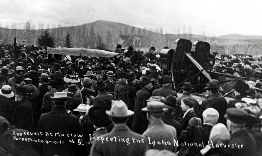Colonel Roosevelt inspecting one of the Idaho National Harvesters on the University of Idaho campus, April 10, 1911. Tomers Butte, center of picture.