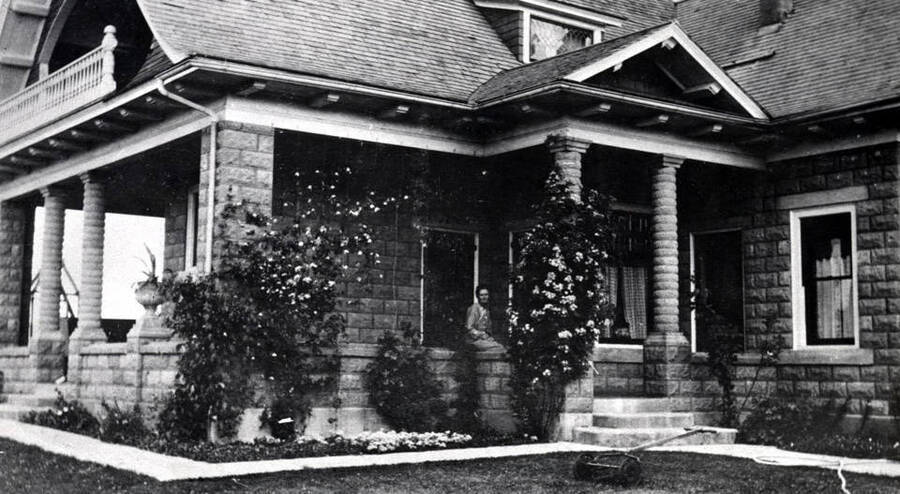 Wylie A. Lauder concrete block residence built about 1907. Located at 1320 Deakin Street at west end of Lauder Avenue. Mrs. Wylie A. Lauder on the porch.