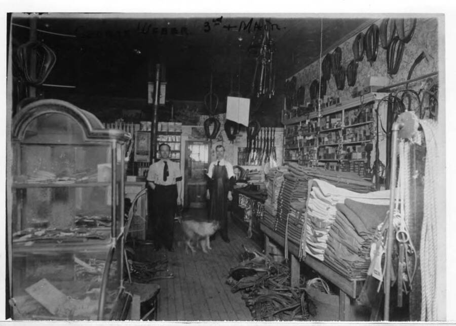 Inside the George Weber Harness Shop at the northeast corner of Third and Main streets. George Weber at left in picture.