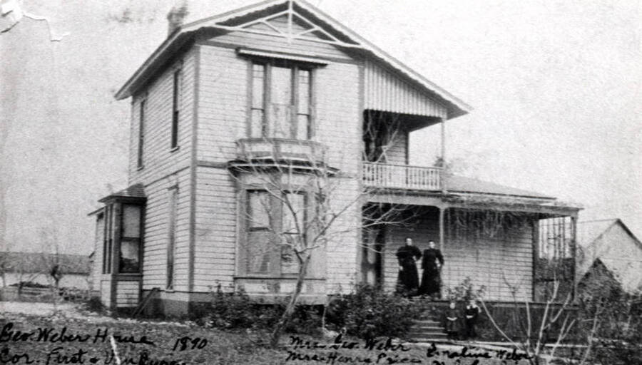 Dr. Reeder residence purchased by George [Gottfried] Weber who lived here until 1945. Weber was Moscow's pioneer harness maker. House was built in the late 1880s. Picture taken 1890. Located at the southeast corner of First and Van Buren streets. Left to right: Mrs. Weber, Mrs. Henry Price, Emaline Weber, and Malcolm Price. Mrs. Weber and Mrs. Price were sisters.