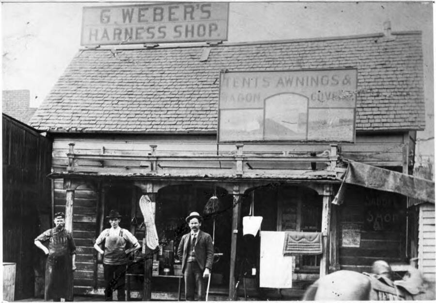 George Weber Harness Shop, believed to be his first store in Moscow established after his arrival in 1879. Location is not known. George Weber with cane at right in picture.