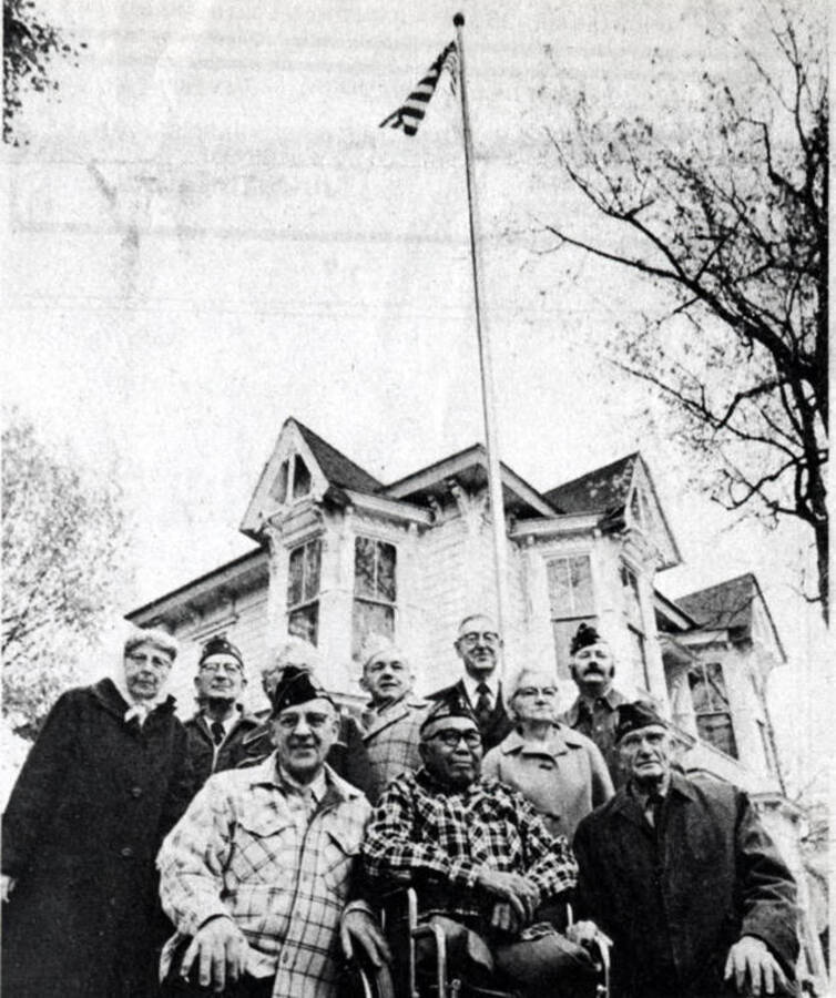 Photo of newspaper photo and caption regarding flag pole dedication
