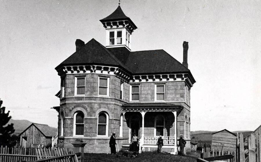 Mason A. Cornwall residence built in 1889 at the southeast corner of Third and Hays streets. Cornwall was a pioneer banker and businessman. He built the Cornwall Building in 1890 located on the south side of Third Street between Main and Washington streets, east of the alley. Left to right: Mason Sr. with cane, Mason H., L. Corwin, Lula, Enos and Earl N. Cornwall. Cornwall residence was built by M.F. Zeigler, a pioneer carpenter and builder. Cupola and lettering over window removed in 1940.