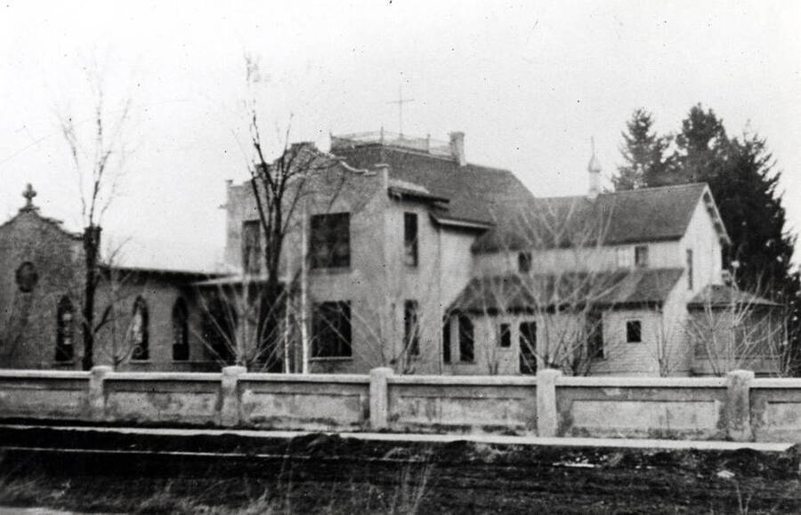 Julia Moore residence purchased by Ursuline Convent in 1908 and later an addition added on the west side. Howard Street in foreground.