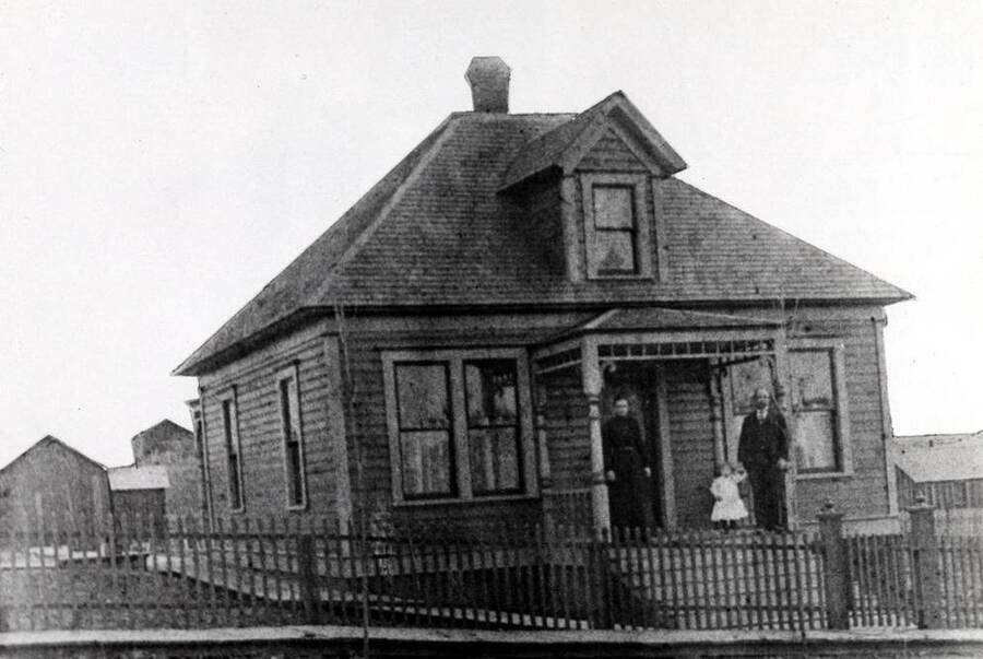Edward T. Christenson residence early 1900s at 806 South Jefferson Street. Standing on porch, Mrs. Christenson, Earl and Mr. Christenson.