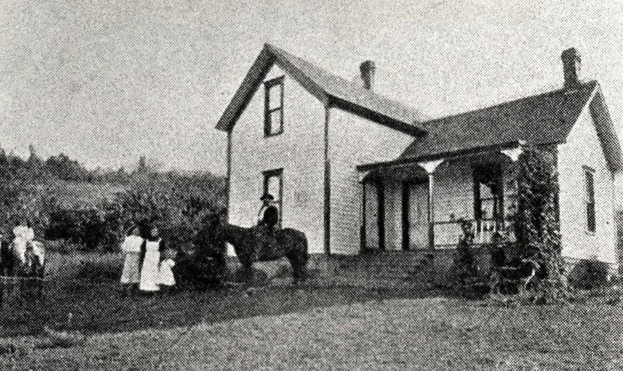 Rev. Daniel Gamble residence about five miles  southeast of Moscow on north side of Paradise Ridge. Early 1900s. Left to right: John, Lola, Margaret, Mrs. Isabella  Gamble, Elizabeth, and Rev. Gamble on horse, Big Shep.