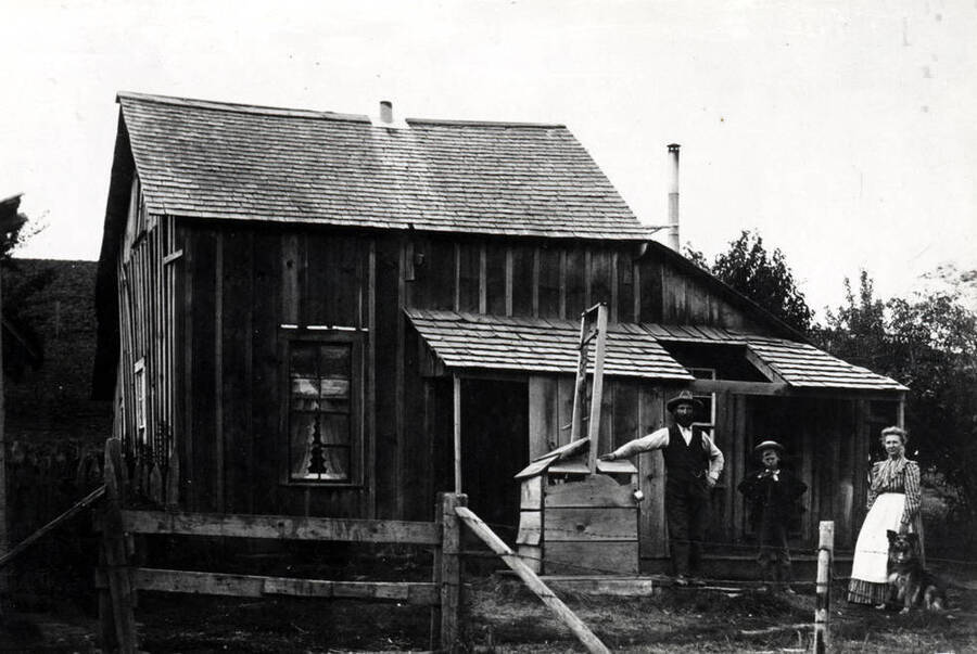 Anderson farmstead northwest of Pullman showing the well with pulley and rope for bringing up a bucket of water. Note the drinking cup on the corner of the well housing. Picture courtesy of J. August Anderson.
