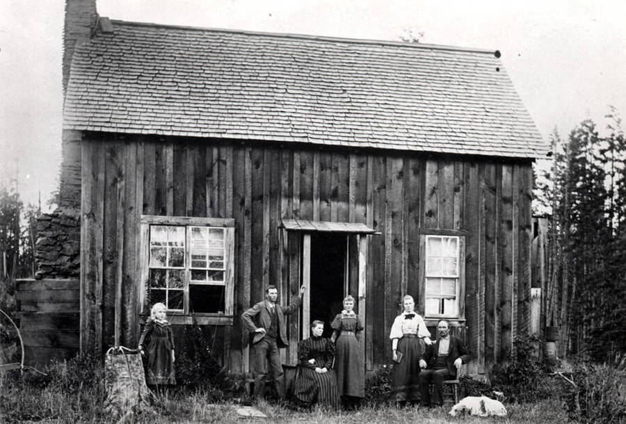 J.R. Strong family and home on Deep Creek northwest of Potlatch. Left to right: Alice [who] married Corliss McElroy, Alva, Mrs. J.R. Strong (mother), Etta [who] married Homer Estes, Eunice [who] married Mr. Moak, and J.R. Strong (father). Picture dated April 1891.