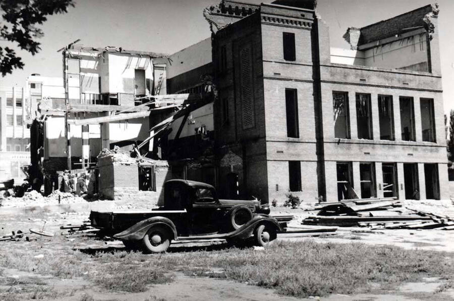Caption reads: "Razing Old Whitworth School, July 1939. Picture by Charles Dimond of Hodgins Drug Store. The new high school shows at extreme left. This location is the site of the new high school Annex as of 1976."