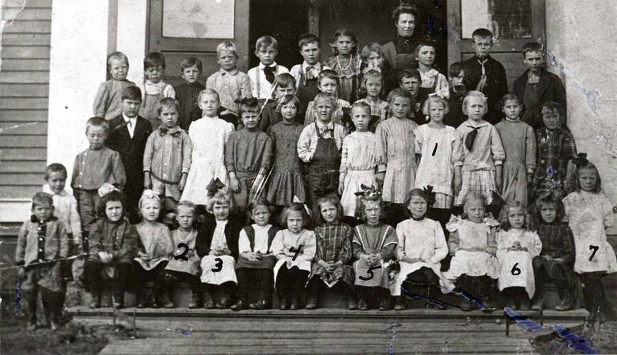Students and teacher about 1910. Ones identified in 1981 were by Caroline Munson Ott  who furnished the picture. 1- Caroline Munson, 2- Mildred Anderson, 3- Lucille Ramstead, 4- Peterson, 5- Helen Hunter, 6- Helen Estes, 7- Helen Nelson; teacher Mrs. St. John. Original picture copied by Clifford M. Ott, November 21, 1981.