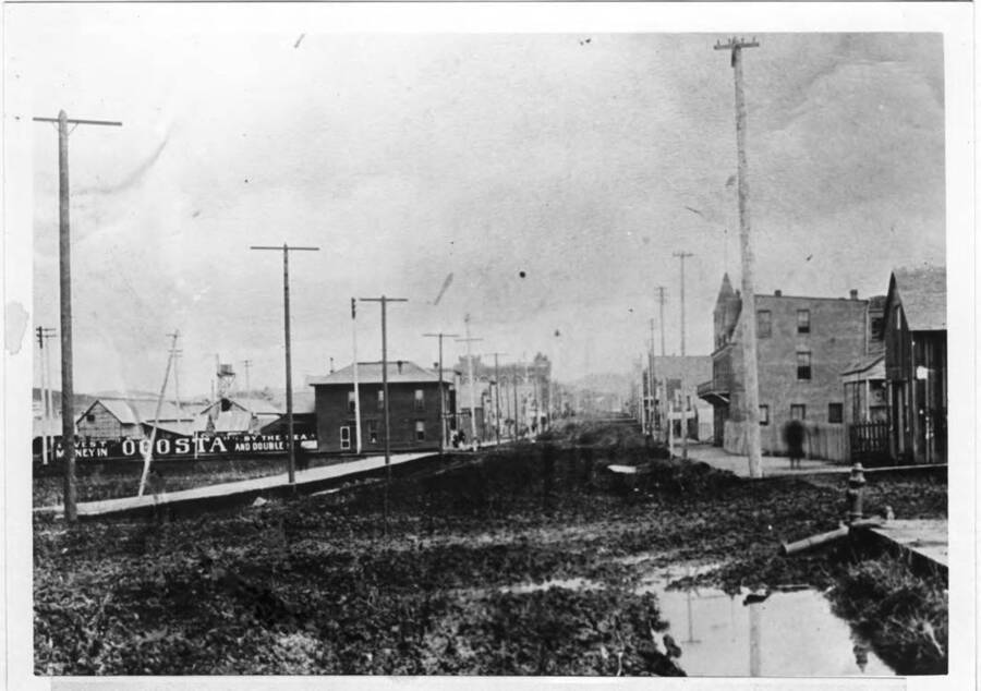First brick building on right, McGregor House later Gritman Hospital, corner Main and Seventh streets. July 4, 1900.