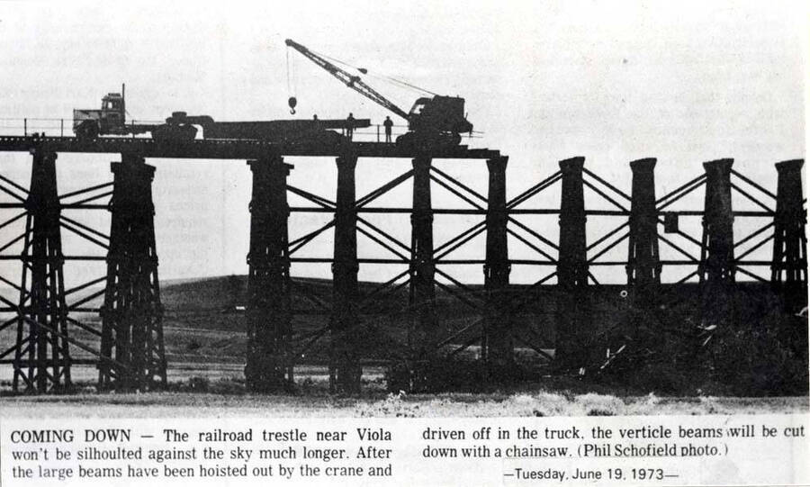 Spokane & Inland Electric Railroad Company trestle about one-half-mile south of Viola station being razed. Latah County Grain Growers warehouse at Viola will be served by the Burlington Northern [Railroad] from Palouse and their warehouse at Estes from Moscow. Railroad tracks between Estes and Viola have been removed.