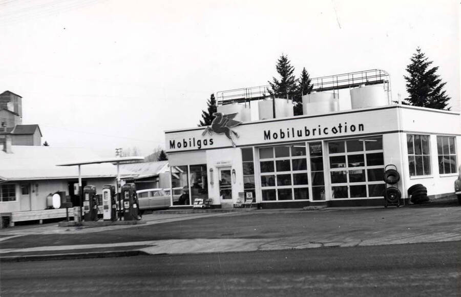 East side of Main Street south of the railroad tracks. Mobil bulk plant over gas station. Washburn-Wilson Seed Company warehouse left.