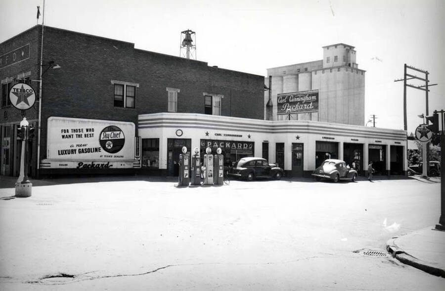 Southwest corner of Sixth and Main streets. Carl Cunningham, Packard dealer and Texaco service station operator. 1940s.