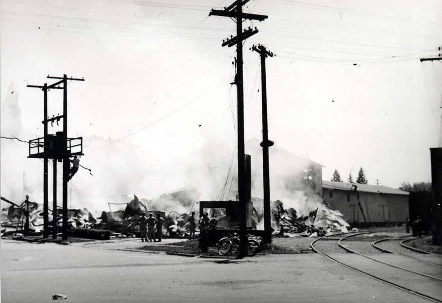 Looking southwest at another view of the smoldering ruins of the Washburn-Wilson Seed Company main processing building, July 7, 1945.