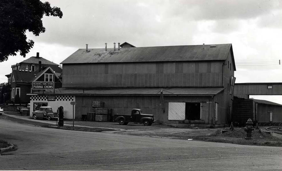 Looking southwest from the intersection of Almon and A streets at the Washburn-Wilson Seed Company barley pearling and feed processing building built in 1946, replacing the building that burned. Picture by Clifford M. Ott about 1955.
