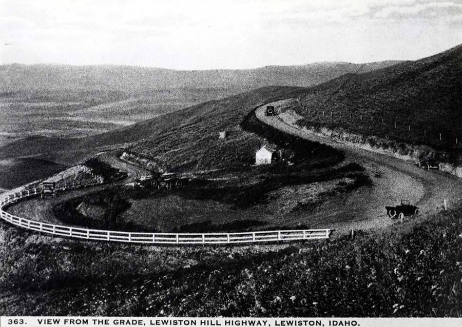 Looking west at horseshoe turn near the top of the old Lewiston Highway grade. Later an iris bed was planted in the area east of the building and cared for  many years. Picture 1919-20.