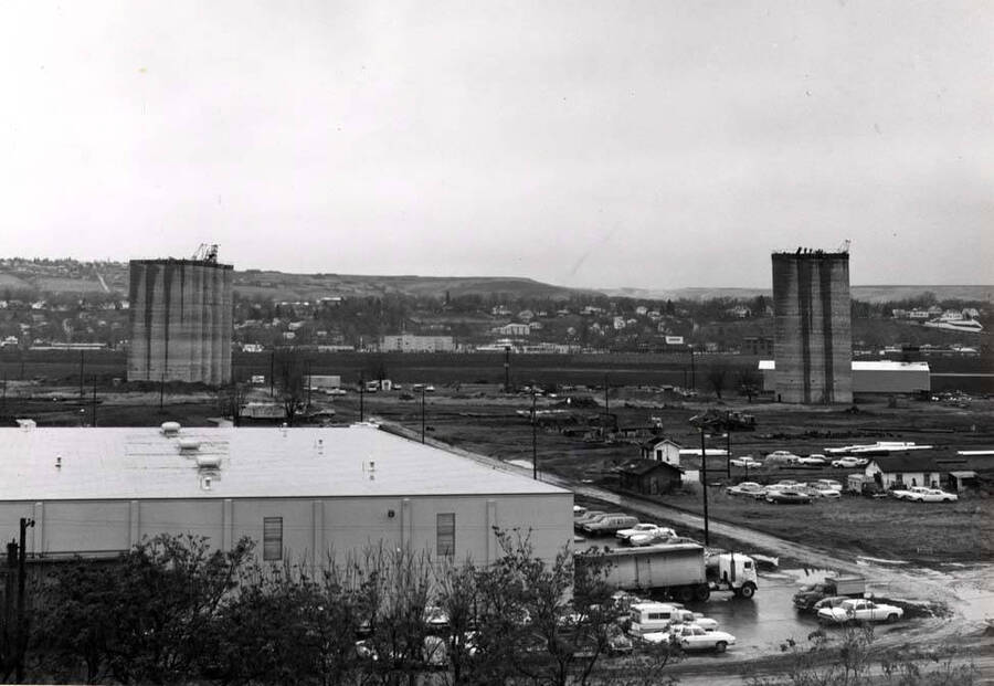 Looking south from the foot of the grade at the new Great Western Store and two new concrete grain elevators. December 20, 1974.