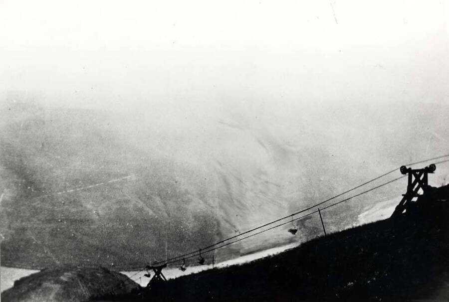 Pioneer picture of a bucket tramway that carried sacked grain from the top of the grade to the bottom where it was stored and later loaded onto boats. Location below Wawawai in the 1890-1900s.