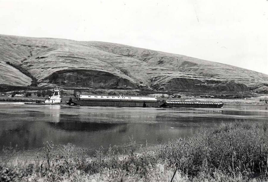 Tugboat pushing barges just below Lower Granite Dam. By Clifford M. Ott 1979.