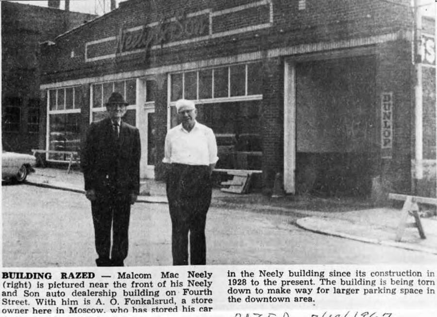 Newspaper clipping: Building Razed - Malcolm [(Mac)] Neely (right) is pictured near the front of his Neely and Son auto dealership building on Fourth Street. With him is A.O. Fonkalsrud, a store owner here in Moscow, who has stored his car in the Neely building since its construction in 1928 to the present. The building is being torn down to make way for larger parking space in the downtown area.