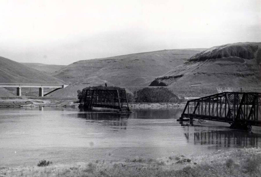 Looking north across Snake River at the area occupied by Riparia and the railroad bridge being razed for the backwater from Lower Monumental Dam. New elevated railroad tracks beyond. Picture by Clifford M. Ott 1969.