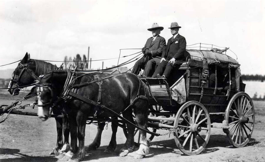 Felix Warren and Governor H.C. Baldridge on stagecoach at University of Idaho pageant, June 11, 1923. Looking northeast with Moscow Mountain in far distance.