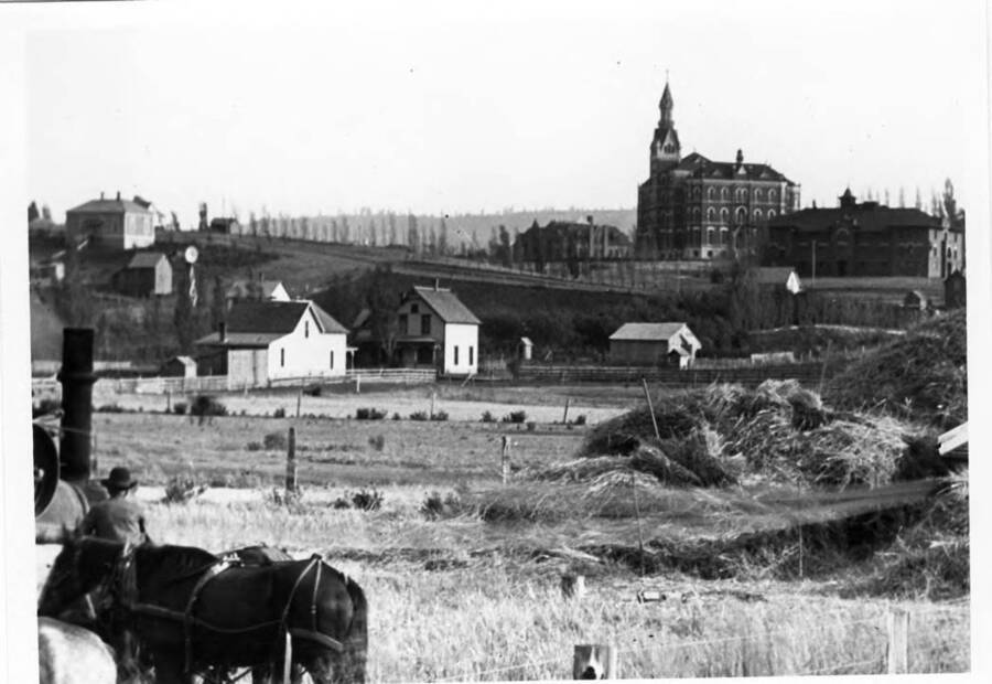 Looking southeast from Moscow-Pullman highway at the University of Idaho. School of Mines, Administration Building, and gymnasium. Paradise Ridge shows in the background.