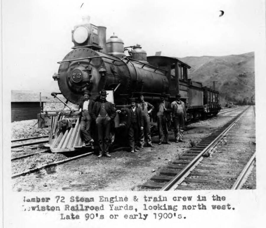 Number 72 steam engine and train crew in the Lewiston Railroad Yards, looking north west. Late 90s or early 1900s.