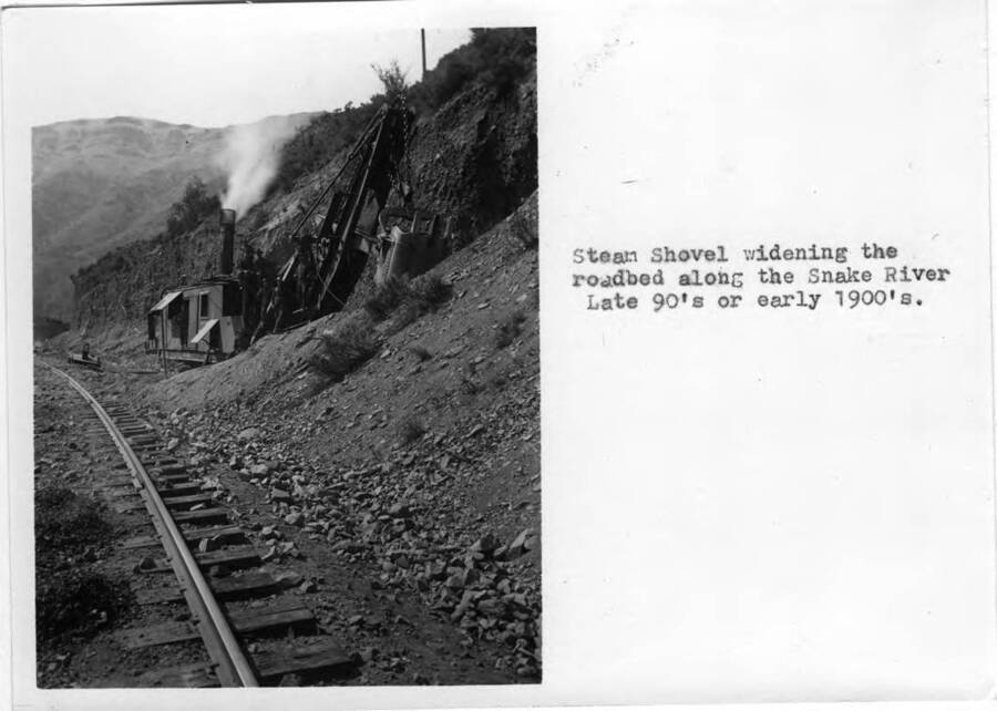 Steam shovel widening the roadbed along the Snake River. Late 90s or early 1900s.