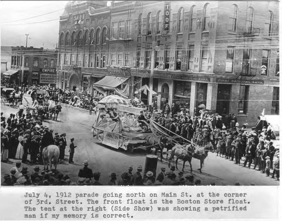Front float is the Boston Store float. Tent at the right (side show) was showing a petrified man, if my memory is correct.