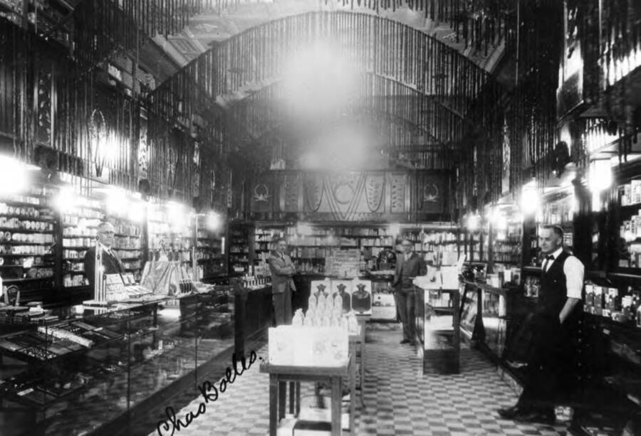 Charles Bolles owner-manager behind counter at left. Frank B. Robinson at right in shirt sleeves. Later he established Psychiana. Picture about 1926.