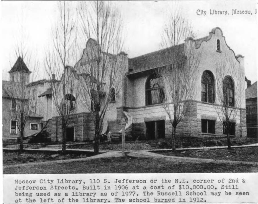 110 South Jefferson Street or the northeast corner of Second and Jefferson streets. Built in 1906 at a cost of 10,000.00. Still being used as a library as of 1977. Russell School may be seen at the left of the library. School burned in 1912.