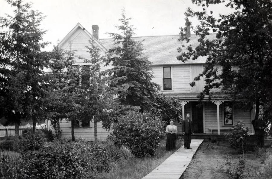Old Latah County Home, located about two miles northwest of Moscow, east of the old Highway 95, now a county road. Home was vacated in 1957 and the inmates [moved] to the new Latah County Nursing Home. Caretakers, Mrs. and Mr. Milton Frazee and son Howard extreme right.