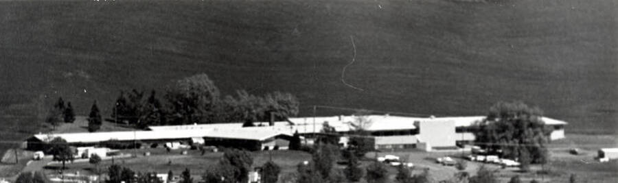 Looking north at the Latah Care Center from top of hill two miles south using a 1200 MM lens, showing new wing at right. By [Clifford M.] Ott June 11, 1982.