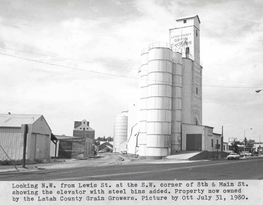 Showing the elevator with steel bins added. Property now owned by the Latah County Grain Growers. Picture by Clifford M. Ott July 31, 1980.