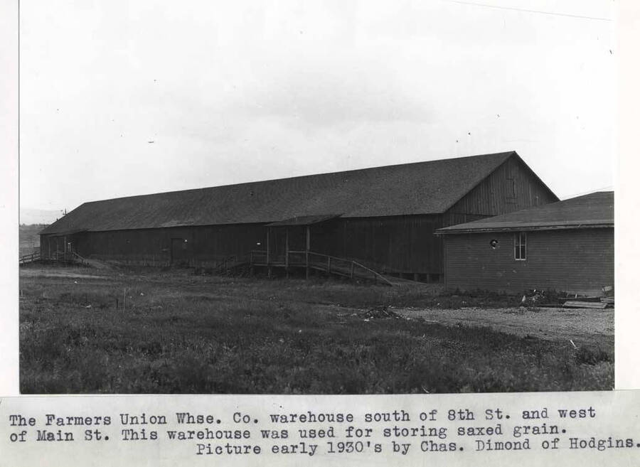 Warehouse south of Eighth Street and west of Main Street. This warehouse was used for storing sacked grain. Picture early 1930' by Charles Dimond of Hodgins.
